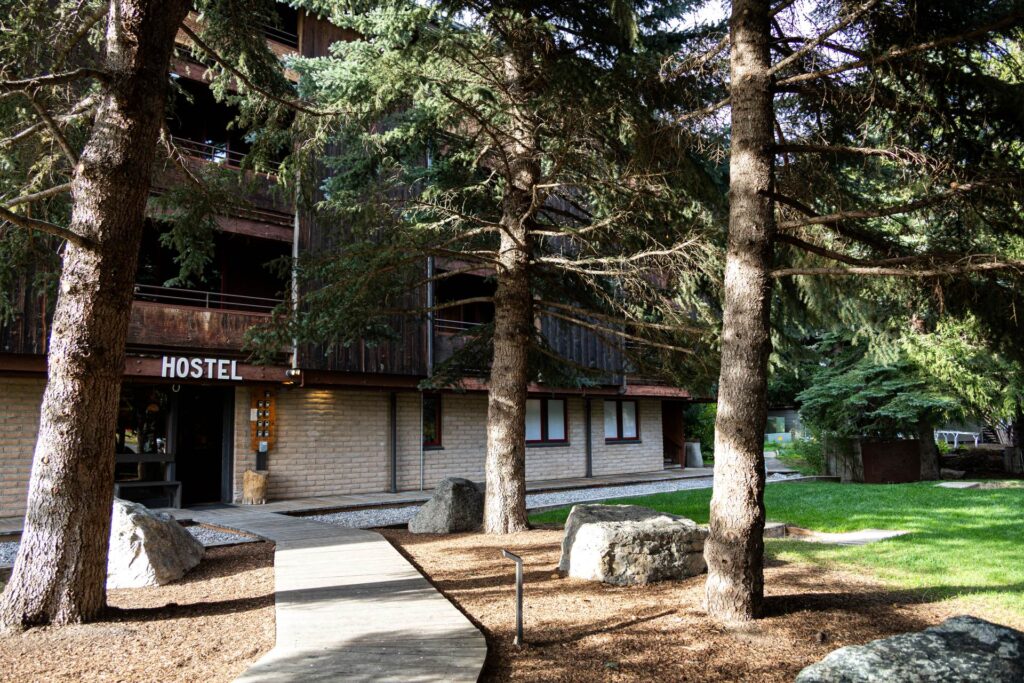 The exterior of The Hostel, showing a sunny front yard