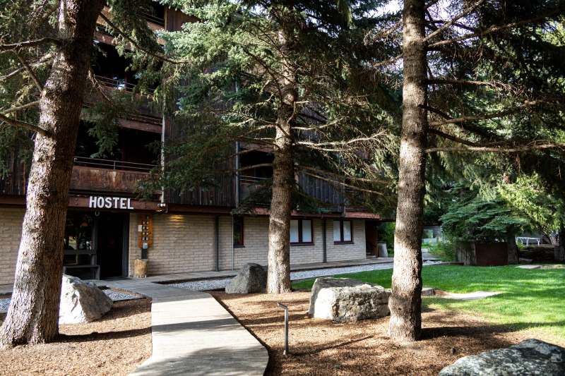 The exterior of The Hostel, showing a sunny front yard