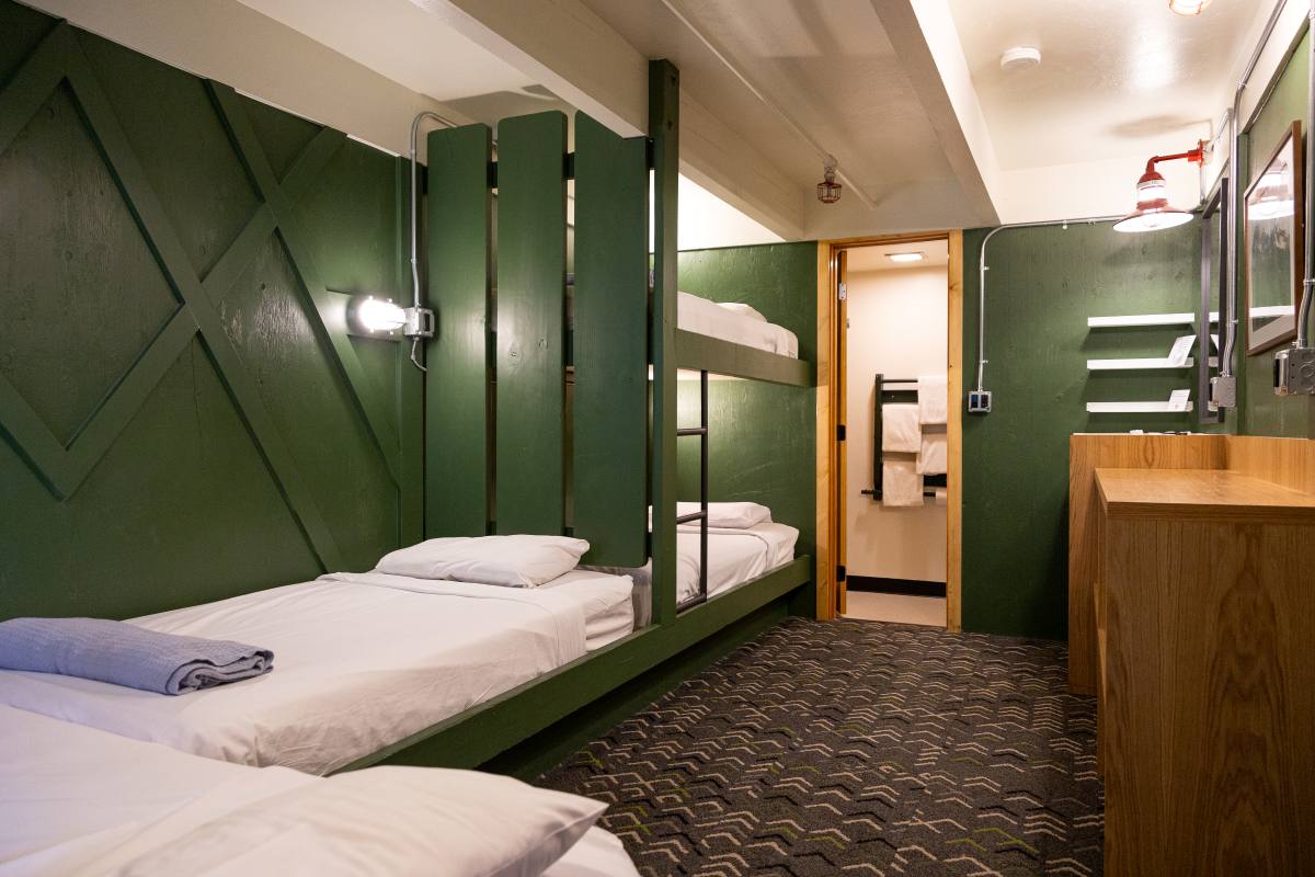 Private twin room with green walls and bunk-style beds