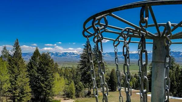 A disc golf basket in the mountains