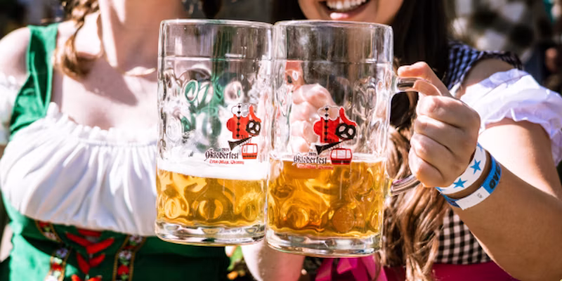 two women holding large beers
